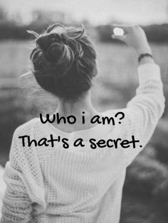 a woman is holding her hand up to the sky with an inscription that reads, who i am? that's a secret