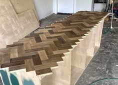 an unfinished wall with wood planks in the process of being installed to it's side