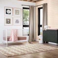 a baby's room with a crib, dresser and pictures on the wall