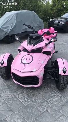 a pink toy car sitting on top of a parking lot