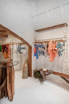 a room that has some clothes hanging on the wall and a table in front of it