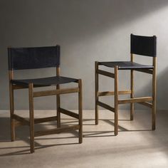 two wooden chairs sitting next to each other