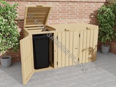 a large wooden trash can sitting next to a brick wall and potted planters