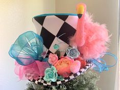 a hat decorated with feathers and flowers on top of a tree