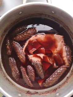 there are many sausages cooking in the pot