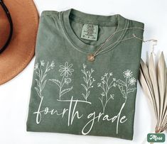 Comfort Colors Fourth Grade Shirt, Wildflower 4th Grade Teacher TShirt, Teacher Team Shirts, Cute Back to School Shirt, Kids First Day of Fourth Grade Tee ✧ WHY  YOU'LL  LOVE IT ✧  ⋒ Comfort Colors® tees are garment-dyed shirts that are timeless classics and will never pile.  ⋒ Trendy retro vintage look and gorgeous colors.  ⋒ Amazingly soft and comfy. Perfect with any shorts, skirts, jeans, leggings, or nothing but undies around the house. ⋒ Created with quality in mind, it's made from 100% ring-spun cotton. ⋒ Will last for years with its double-needle stitched neckline, sleeves, and bottom-hems. ⋒ Garment is made with the most expensive dyeing process, reducing shrinking up to 99%. ⋒Comfort Colors®, through Gildan's Community Investment Program, supports education, the environment, human Tshirt Ideas For Teachers, First Day Of Fourth Grade, Bliss Products, Teacher Team Shirts, 4th Grade Teacher, Teacher Team, Oversized T Shirt Dress, Shirts Cute, Ideas For Teachers