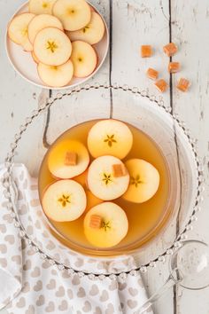 sliced apples in a bowl with honey on the side