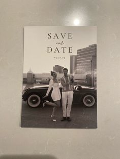 a couple standing next to each other in front of a car with the words save and date on it