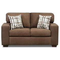 a brown couch with two pillows on the back and one pillow on the top of it