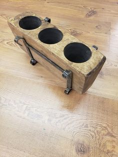 a wooden box with two black holes in it