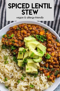 a bowl filled with rice, beans and avocado next to a striped napkin