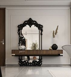 a large mirror sitting on top of a wooden table next to a white chair in a room