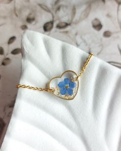 💙 This heart bracelet showcases a preserved forget-me-not flower, set in gold-plated stainless steel. The adjustable design makes it a versatile and comfortable accessory. With its delicate blue flower, this handmade bracelet is a thoughtful gift for a wife, blending natural beauty with a timeless, elegant style. ⭐ Please note that this item is made to order, and the details may slightly differ from the photos as it is a handmade product.⭐ 💙 The bracelet size is adjustable in range of 16 cm - Cute Bracelets, How To Preserve Flowers, Heart Bracelet, Love Symbols, Stainless Steel Jewelry, Jewelry Lover, Flower Jewellery, Bracelet Sizes, Chain Link Bracelet