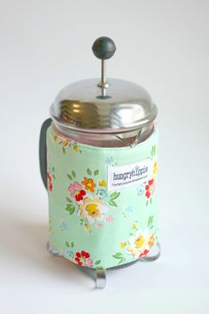 a flowery canister with a metal lid