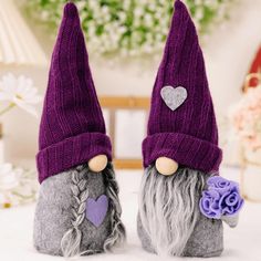 two gnomes with hearts on their hats