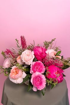 This lovely bowl arrangement mixes three kinds of garden roses: Juliet, Millicent, and Keira along with Coral Charm peonies, grevillea, thyme, Israeli ruscus, and fatsia leaves in a treasured ceramic dish. Garden Rose Arrangement, School Live, Coral Charm Peony, Gorgeous Gardens, Thyme