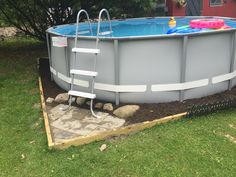 an above ground swimming pool with ladders on the side and inflatable toys