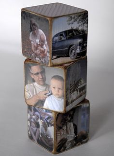 three stacked cubes with pictures of people and cars on them, one has a baby in the middle