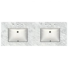 two white sinks sitting next to each other on top of a marble countertop in a bathroom