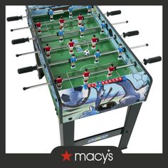 a close up of a foosball table with soccer players on it