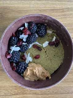 a bowl filled with fruit and nuts on top of a wooden table