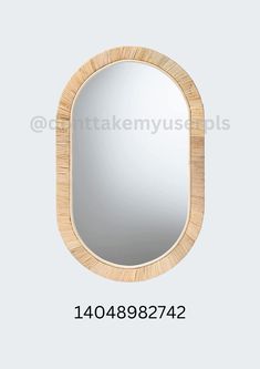 an oval mirror with a wooden frame on the top and bottom, which has been made from