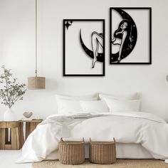 two paintings on the wall above a bed in a room with white sheets and pillows