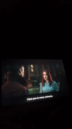 a tv screen with the words i love you in every language on it, and an image of a man standing next to a woman