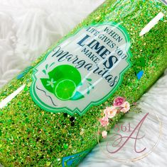 a green bottle with glitter on it that says limes and mardi gras