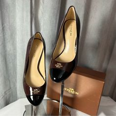 Absolutely Gorgeous Pair Of Patent Leather Coach Pumps In Dark Brown And Black With Gold-Toned Coach Logo Pinned At Toe. These Pumps Are Perfect In Every Way! Flawless And New With Original Box! Perfect For Work And Any Formal Setting. Brought To You By Bev @Bevsboutiques Brown Patent Leather Heels For Work, Coach Black Heels For Work, Coach Brown Heels With Branded Insole, Coach Brown Pointed Toe Heels, Coach Brown High Heel Shoes, Coach Brown Almond Toe Heels, Coach Brown Heels For Formal Occasions, Formal Coach Brown Heels, Pink Strappy Heels