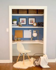 a white chair sitting on top of a wooden floor in front of a book shelf