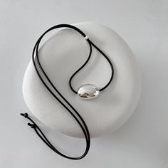 🫘Minimalist Black Cord Necklace with Silver Bean Pendant 🫘 Made with a black leather-like string cord and featuring a bold chunky bean pendant in sterling silver. The self-adjustable length allows for personalized comfort and style. The minimalist design and simple, clean lines make it a versatile accessory that complements any outfit, making it an ideal choice for summer wear. **This Made-to-Order necklace may take up to 2-3 weeks to dispatch if silver components are temporarily unavailable. Modern Black Jewelry With Sliding Knot, Modern Silver Necklace With Adjustable Cord, Minimalist Choker Necklace With Sliding Knot, Silver Necklaces With Adjustable Cord For Everyday, Silver Necklace With Adjustable Cord For Everyday, Black Sterling Silver Necklace With Adjustable Cord, Ear Cuff Piercing, Cord Choker, Minimalist Summer