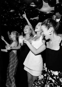 black and white photo of people at a party with confetti in the air