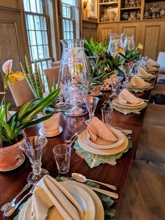 the table is set with dishes and place settings