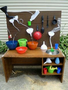 a wooden table topped with lots of bowls and utensils on top of it