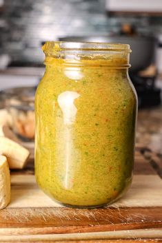 an easy sofrito recipe in a glass jar on a cutting board next to sliced bananas