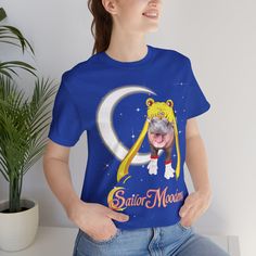 a woman wearing a sailor moon t - shirt with a cat on it's chest