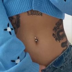 a woman with tattoos on her stomach