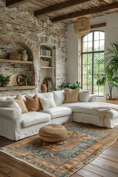 a living room with brick walls and wooden floors