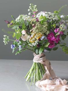 a bouquet of flowers tied up on a table