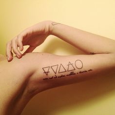 a woman with a tattoo on her arm that says,'i am tao '