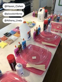 pink plates and utensils are sitting on the kitchen counter