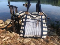 a purse sitting on the ground next to a lake