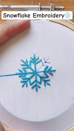 someone is stitching a snowflake embroidery pattern