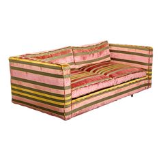 a pink and brown striped couch sitting on top of a white floor