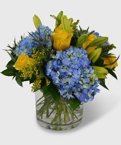 a vase filled with blue and yellow flowers