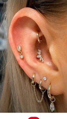 an ear with three different types of piercings on it