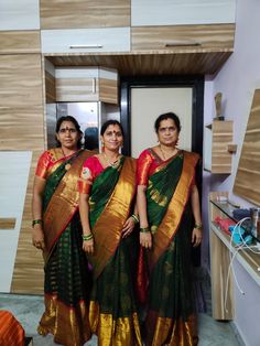 two women in sari standing next to each other