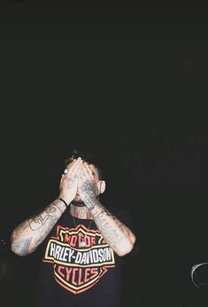 a man with tattoos covering his face