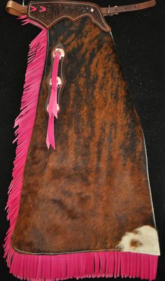 a pink and brown cow hide with fringes on it